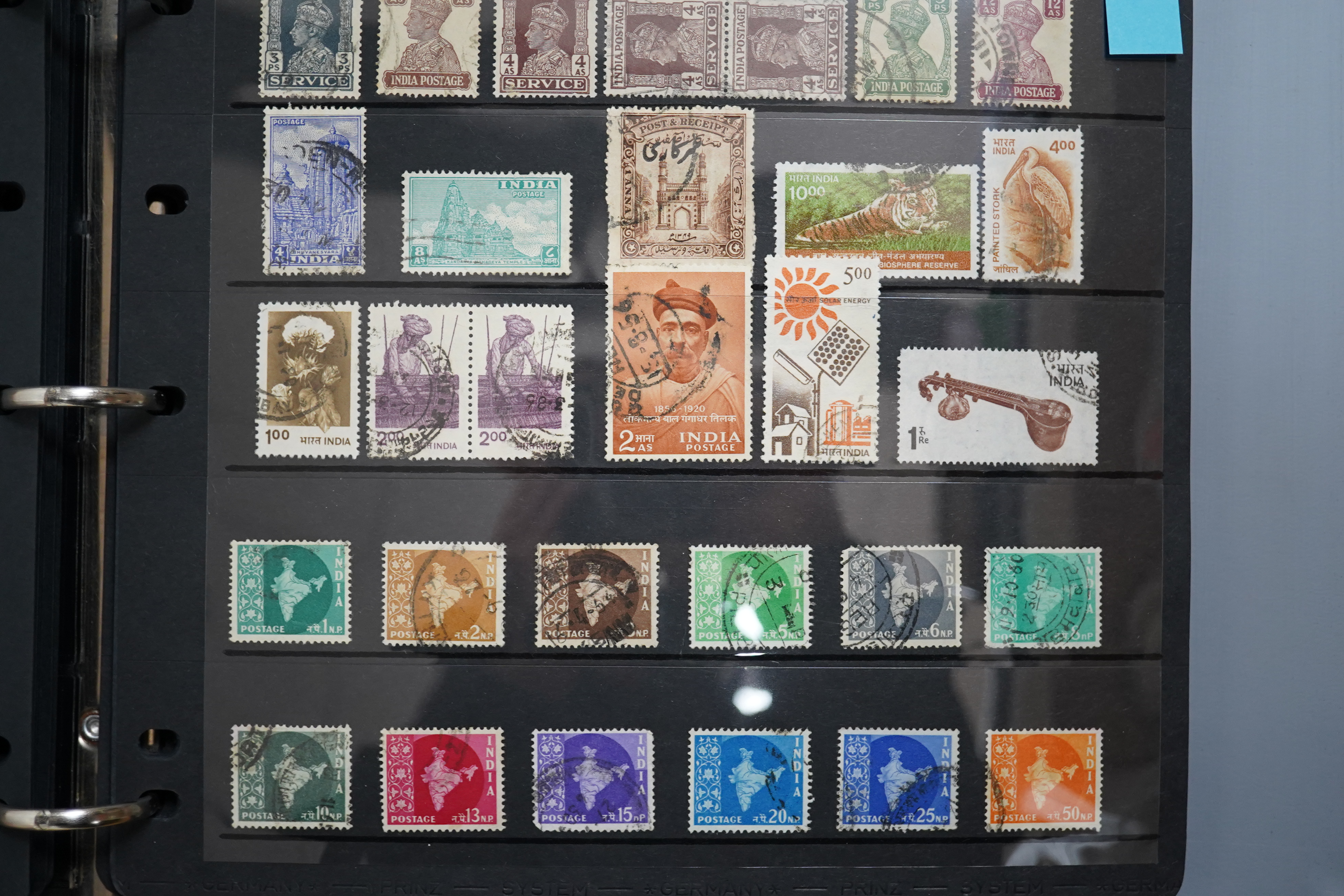 A four albums of mixed stamps, including world and commonwealth, first day covers and an empty album.